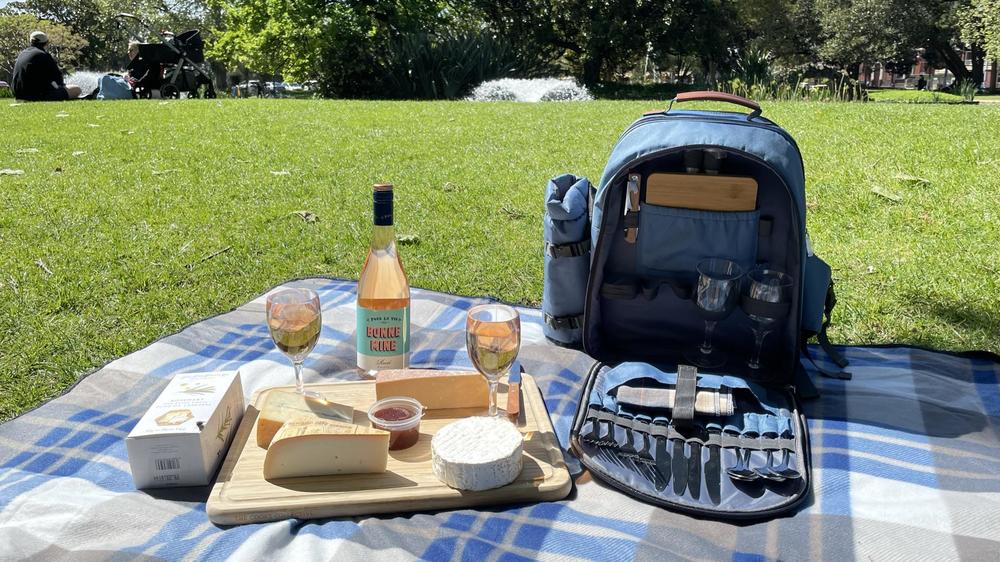 A picnic kit including cheese, wine, cutlery and glasses